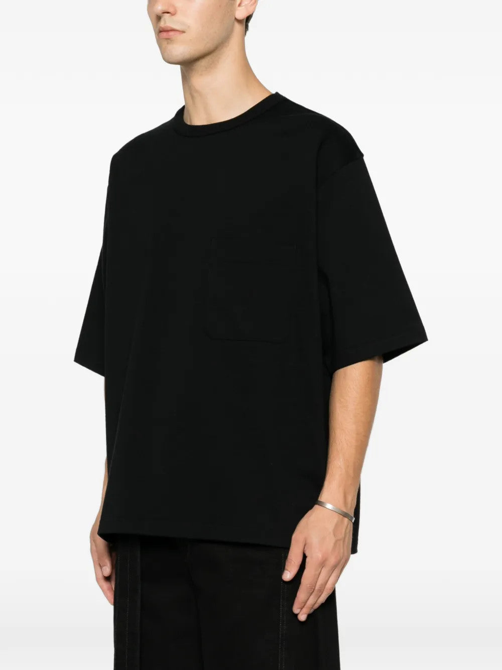 Black t-shirt worn by a person, showing the t-shirt fit