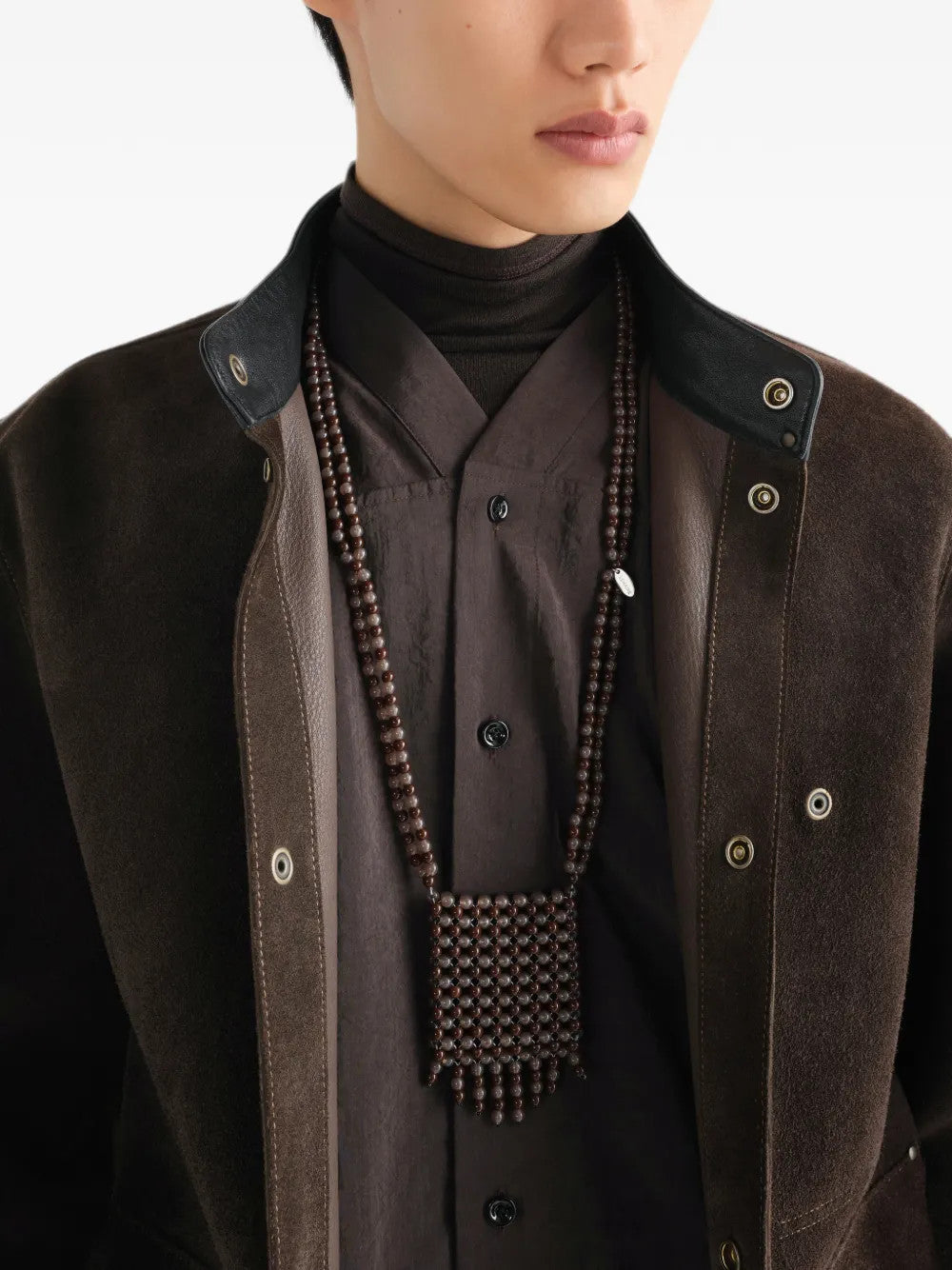 Brown jewelry worn by a person, showing the jewelry fit