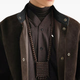 Brown jewelry worn by a person, showing the jewelry fit