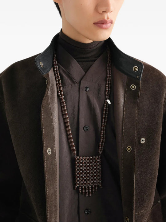 Brown jewelry worn by a person, showing the jewelry fit