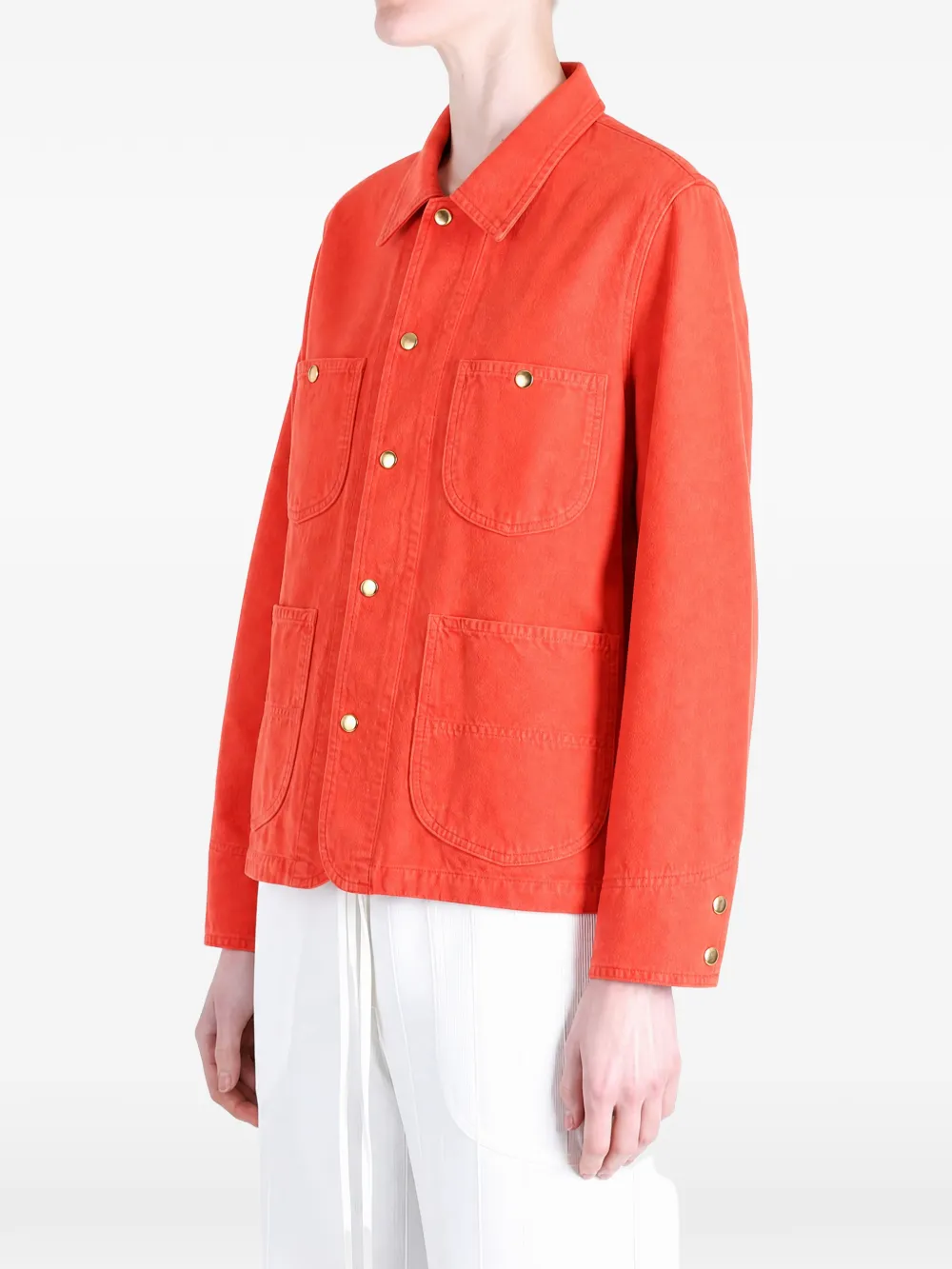 Orange jacket worn by a person, showing the jacket fit