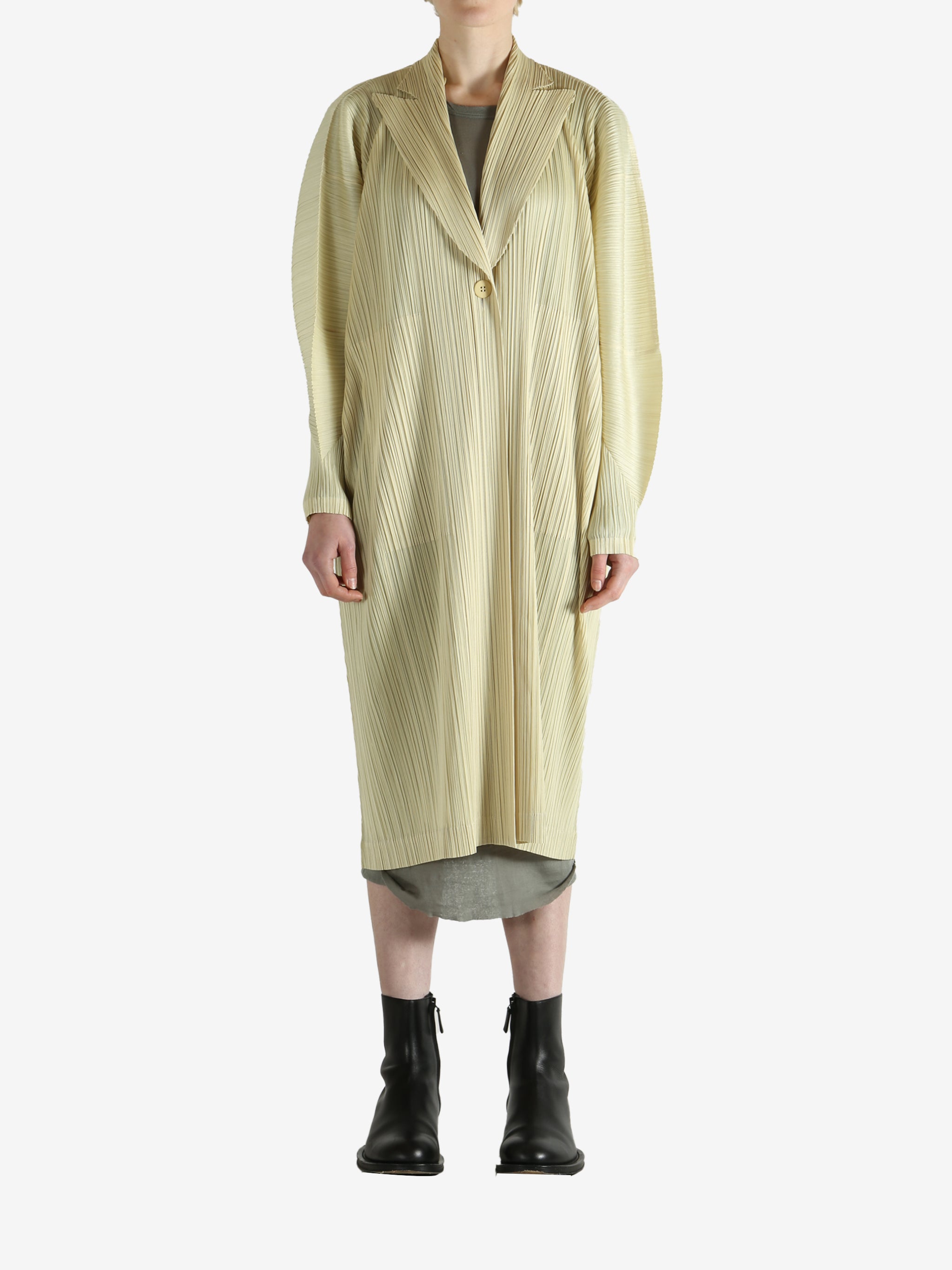 Yellow coat worn by a person, showing the coat's fit