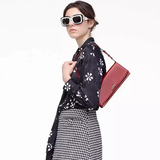 Red bag worn by a person, showing the bag's fit