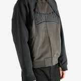 Brown jacket worn by a person, showing the jacket's fit