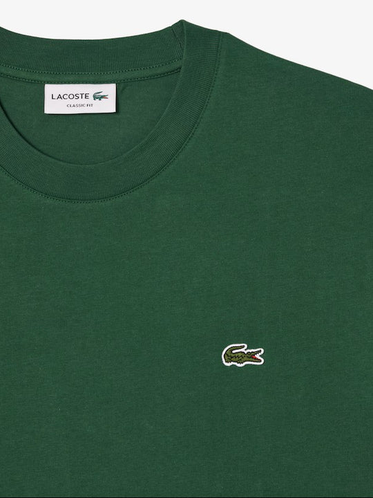 Close up of the green t-shirt, showing texture of the cotton fabric