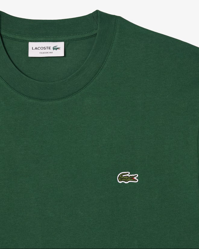 Close up of the green t-shirt, showing texture of the cotton fabric