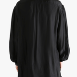 Black shirt worn by a person, showing the shirt's fit