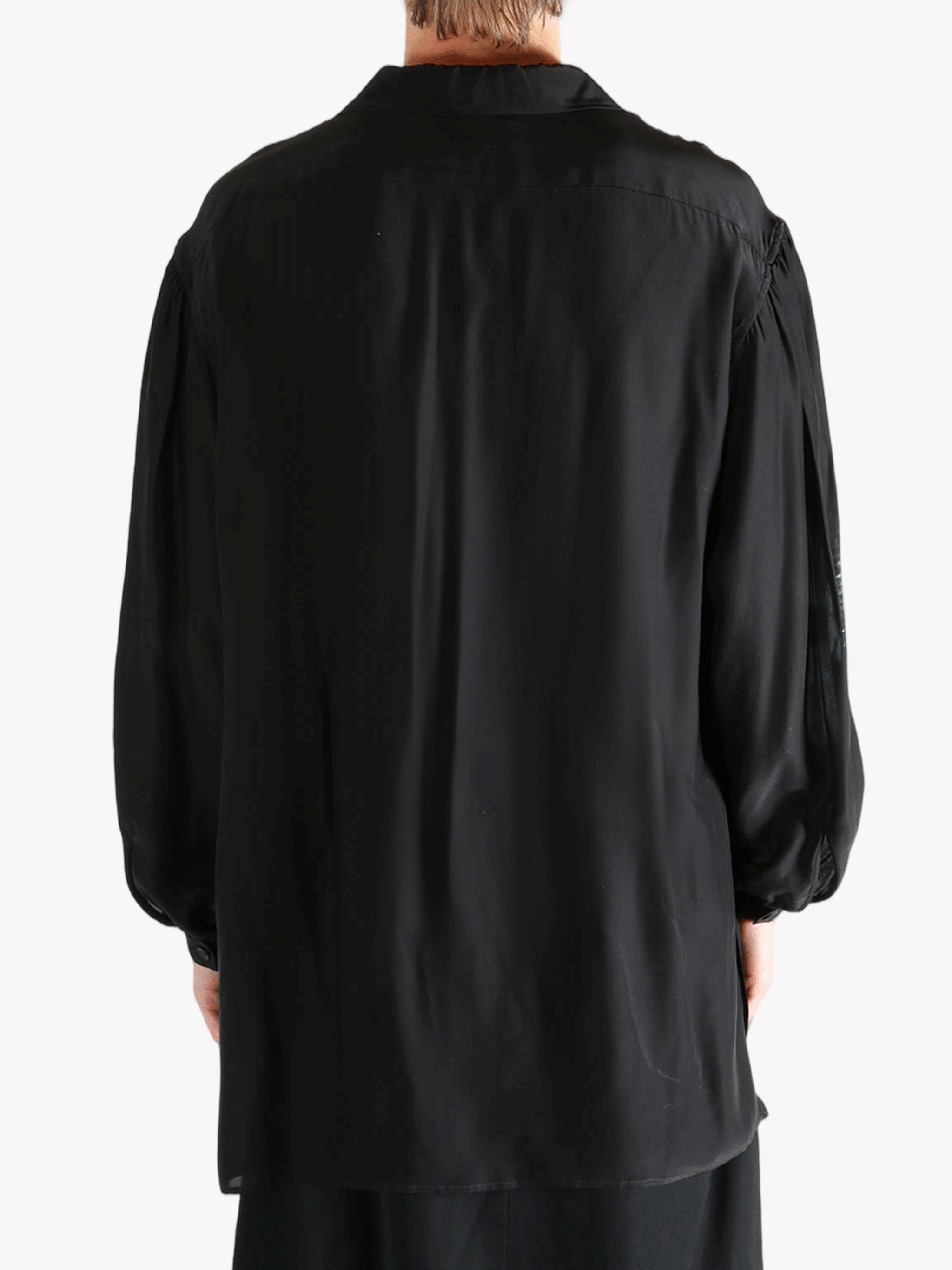 Black shirt worn by a person, showing the shirt's fit
