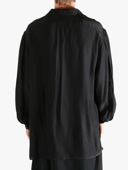 Black shirt worn by a person, showing the shirt's fit