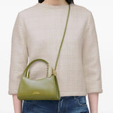 Green bag worn by a person, showing the bag's fit