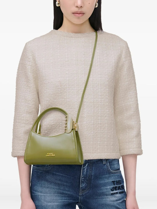 Green bag worn by a person, showing the bag's fit