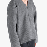 Grey sweater worn by a person, showing the sweater fit
