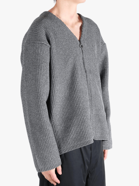 Grey sweater worn by a person, showing the sweater fit