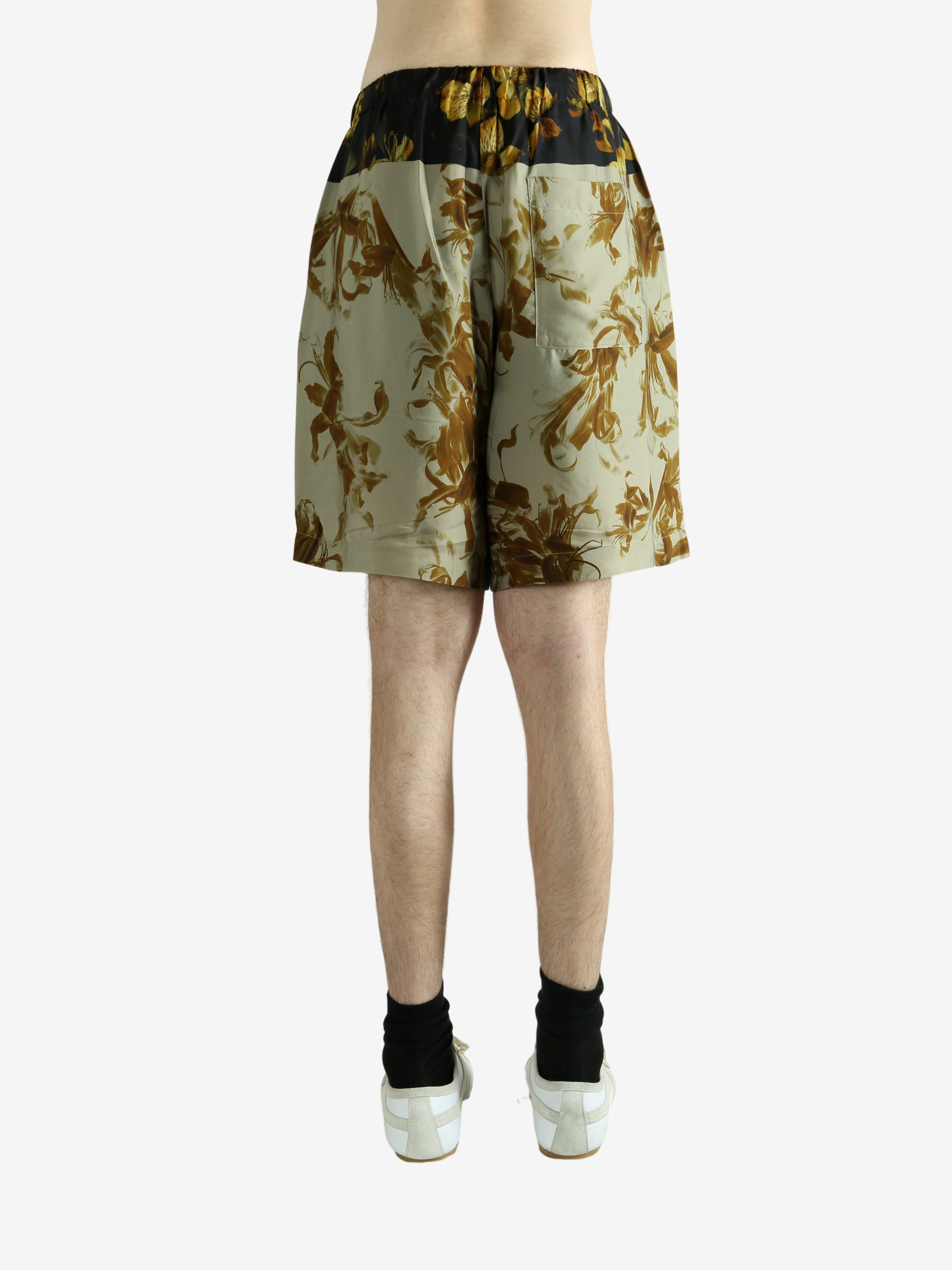 Green pants worn by a person, showing the pants' fit