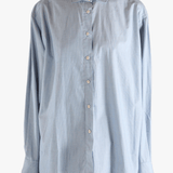 Blue shirt worn by a person, showing the shirt's fit
