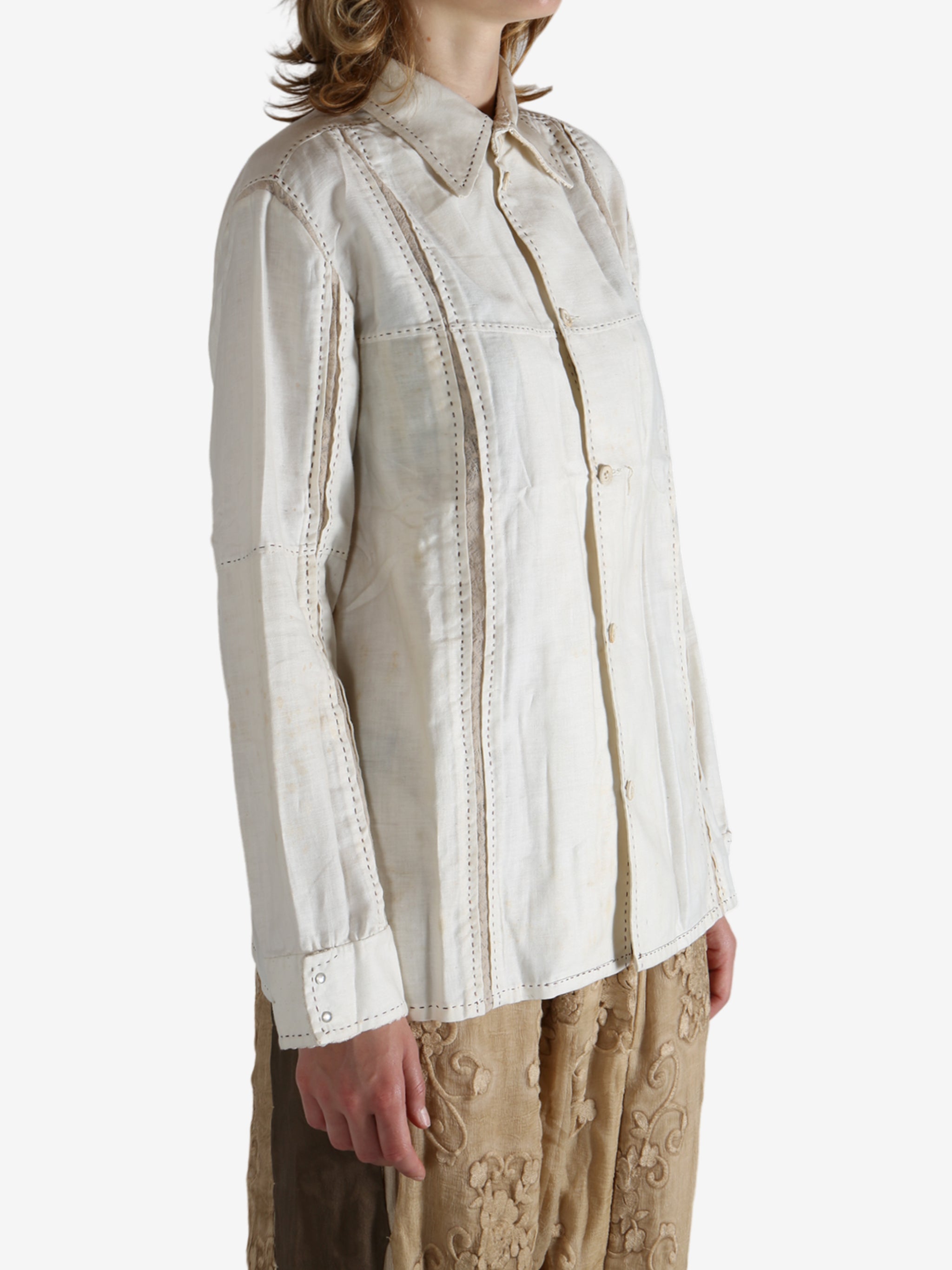 White shirt worn by a person, showing the shirt's fit