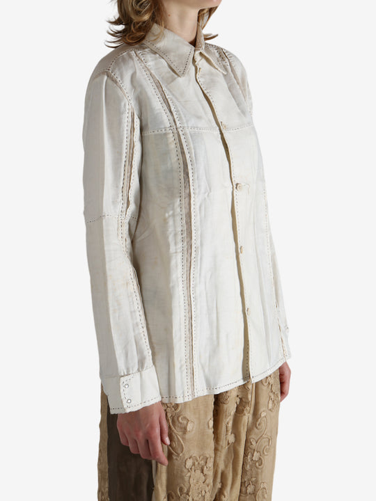 White shirt worn by a person, showing the shirt's fit