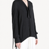 Black shirt worn by a person, showing the shirt fit