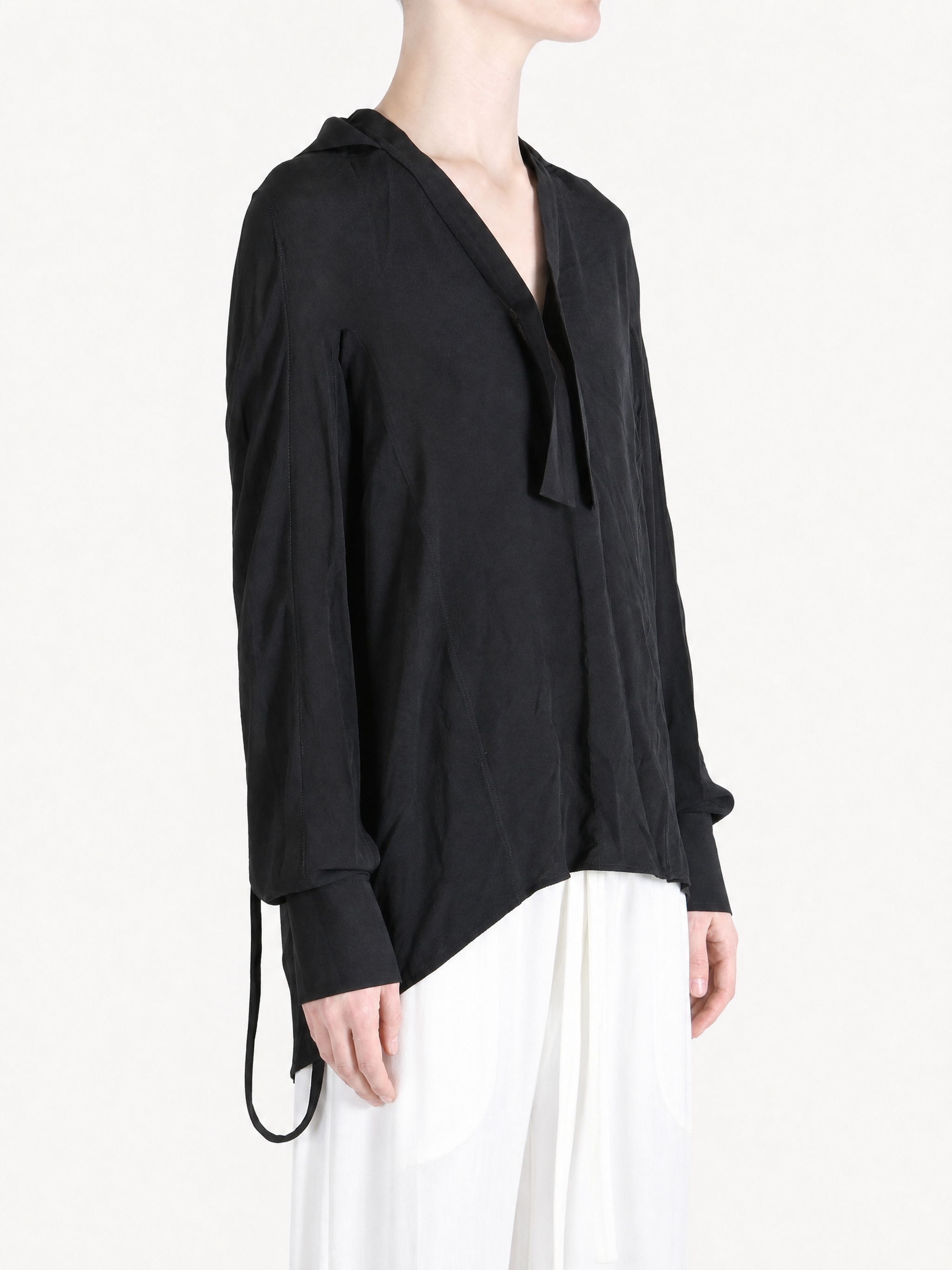 Black shirt worn by a person, showing the shirt fit