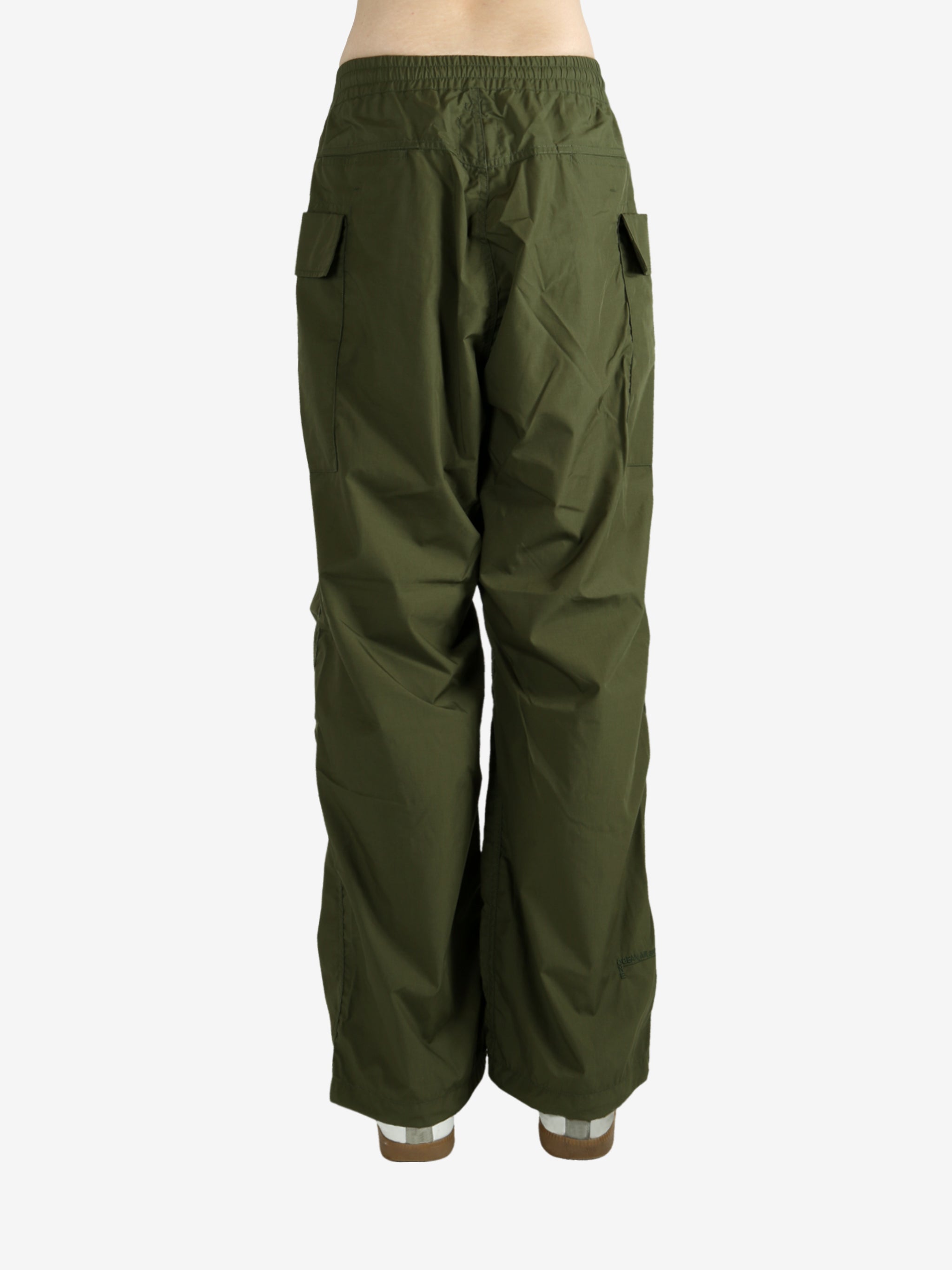 Green pants worn by a person, showing the pant’s fit