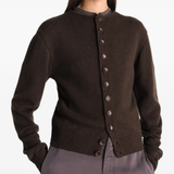 Brown knitwear worn by a person, showing the knitwear's fit