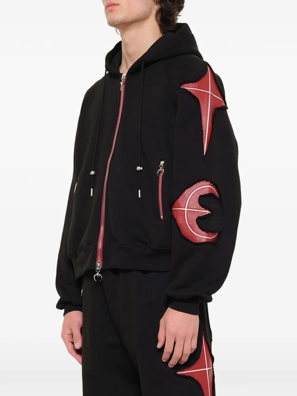 Black hoodie worn by a person, showing the hoodie fit