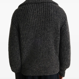 Black cardigan worn by a person, showing the cardigans  fit