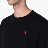 Black sweatershirt worn by a person, showing the sweatershirt's fit