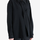 Black shirt worn by a person, showing the shirt's fit