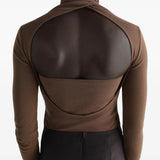 Brown top worn by a person, showing the top fit