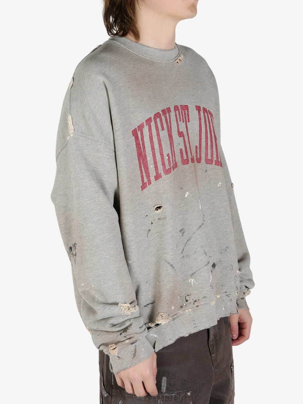 Grey sweatshirt worn by a person, showing the shirt's fit