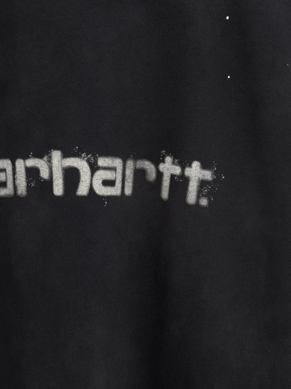 Close up of Black t-shirt, showing texture of the 100% organic cotton made fabric