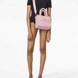 Pink bag carried by a person, showing the bag's fit