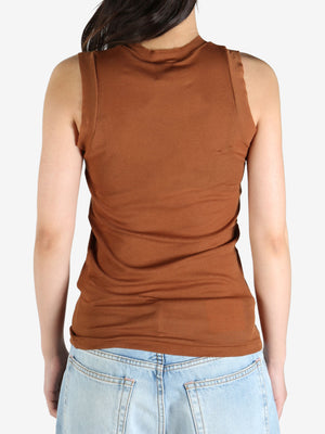 Brown top worn by a person, showing the top's fit