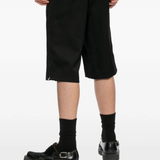 Black shorts worn by a person, showing the shorts's fit