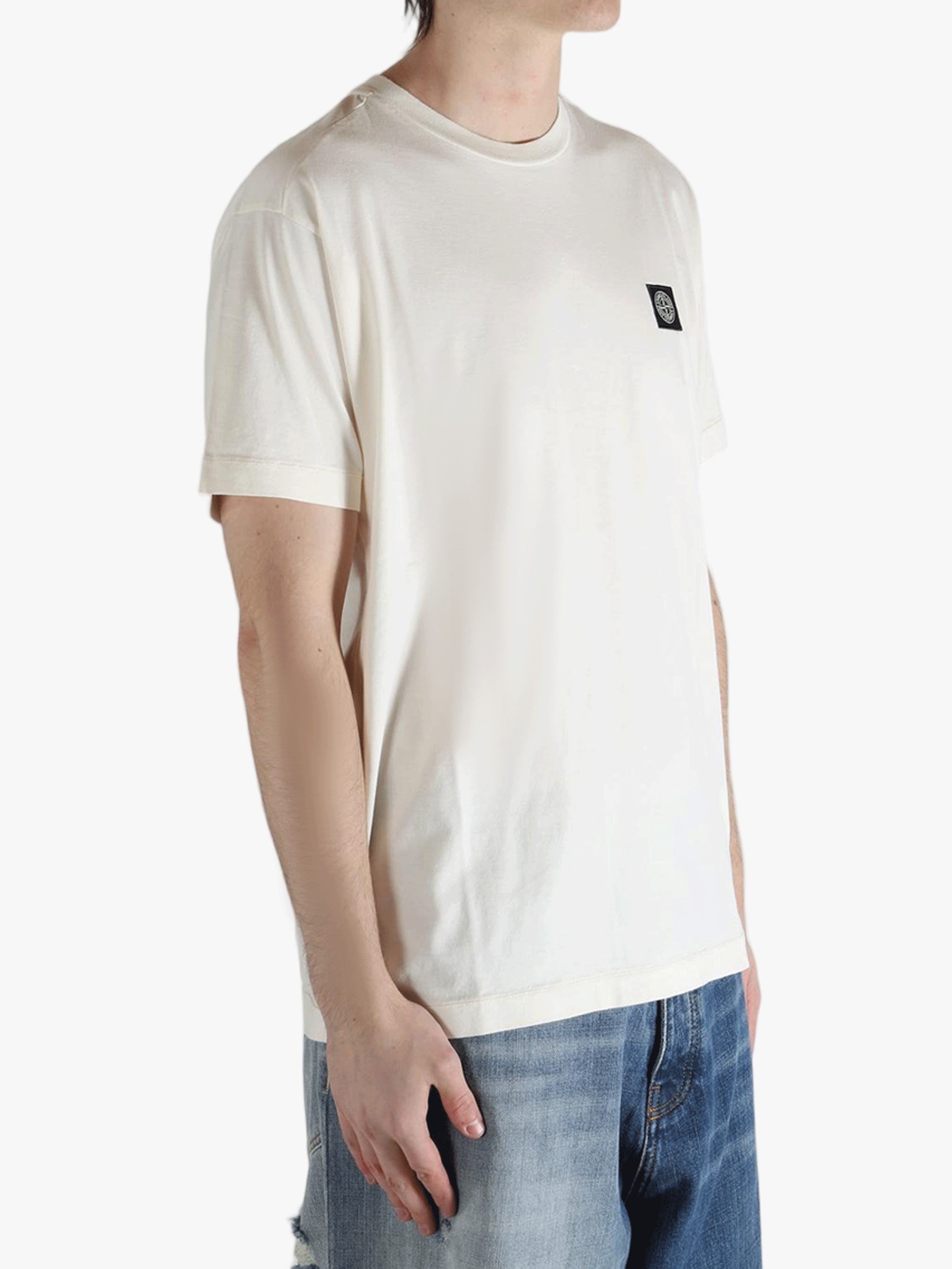 White t-shirt worn by a person, showing the shirt's fit