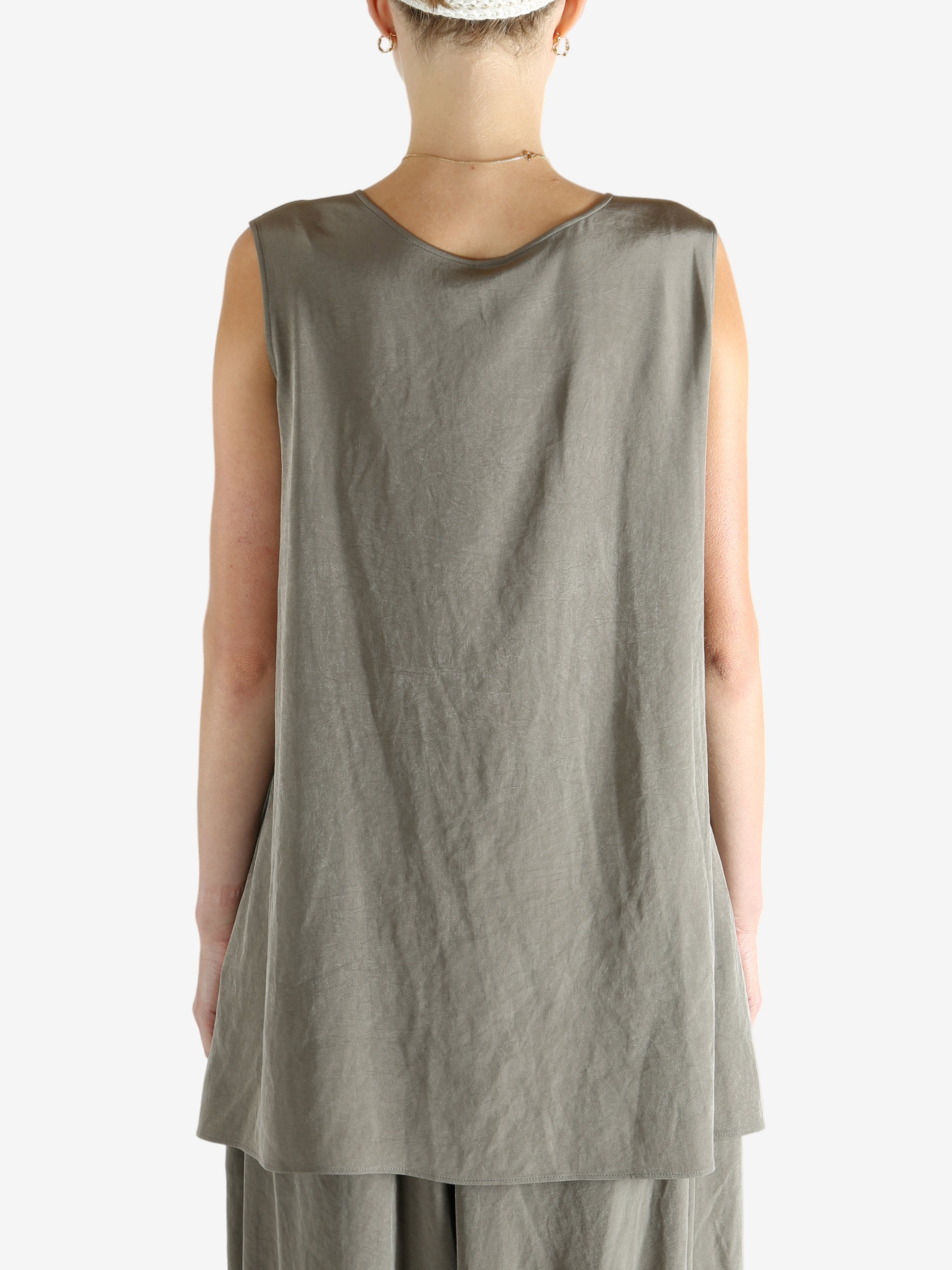 Grey tops worn by a person, showing the tops fit