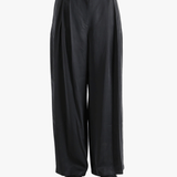 Black pants worn by a person, showing the pants fit