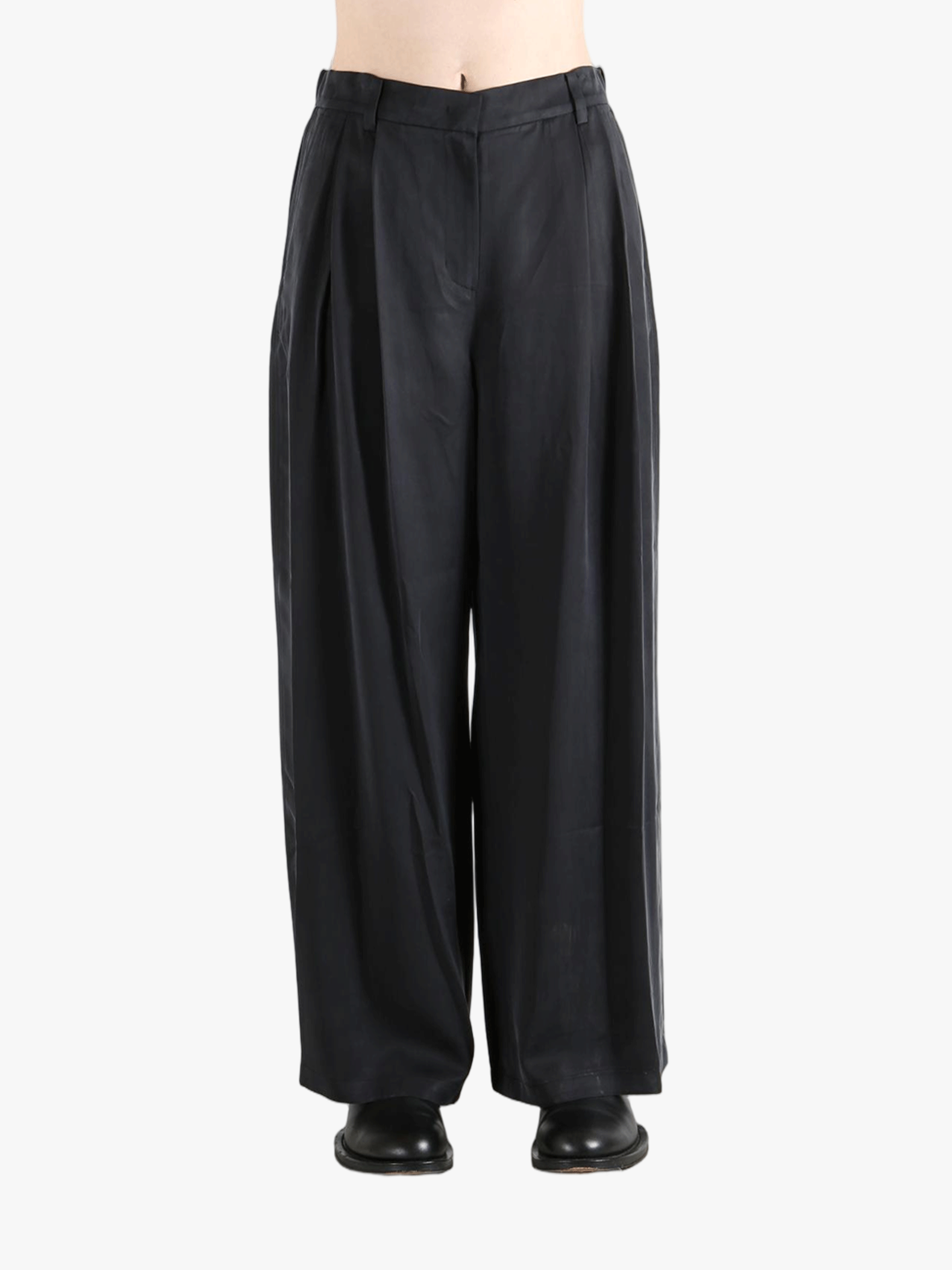 Black pants worn by a person, showing the pants fit