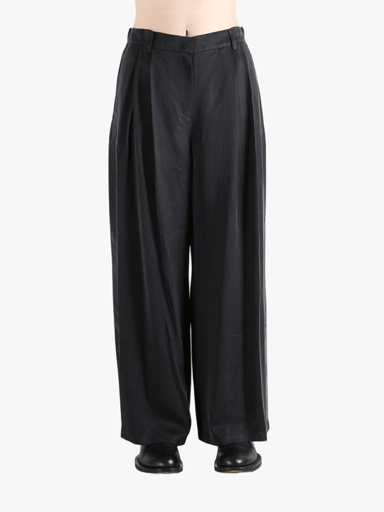 Black pants worn by a person, showing the pants fit