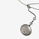 Close up of grey jewelry, showing texture of the siver(925) fabric