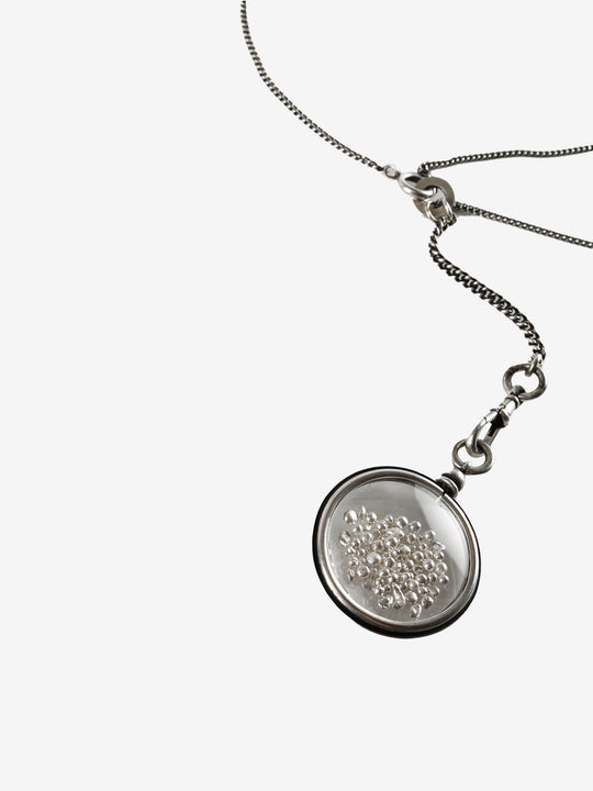 Close up of grey jewelry, showing texture of the siver(925) fabric