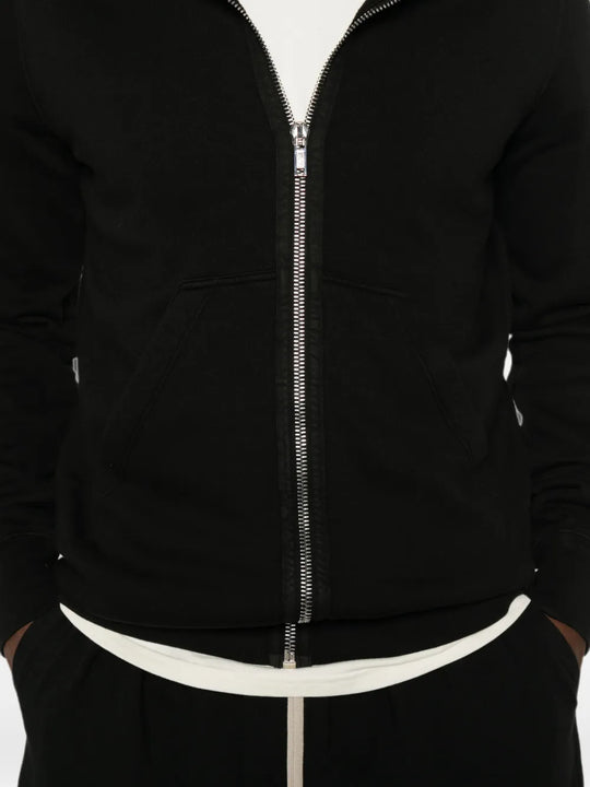 Black hoodie worn by a person, showing the hoodie fit