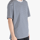 Black tee worn by a person, showing the tees fit