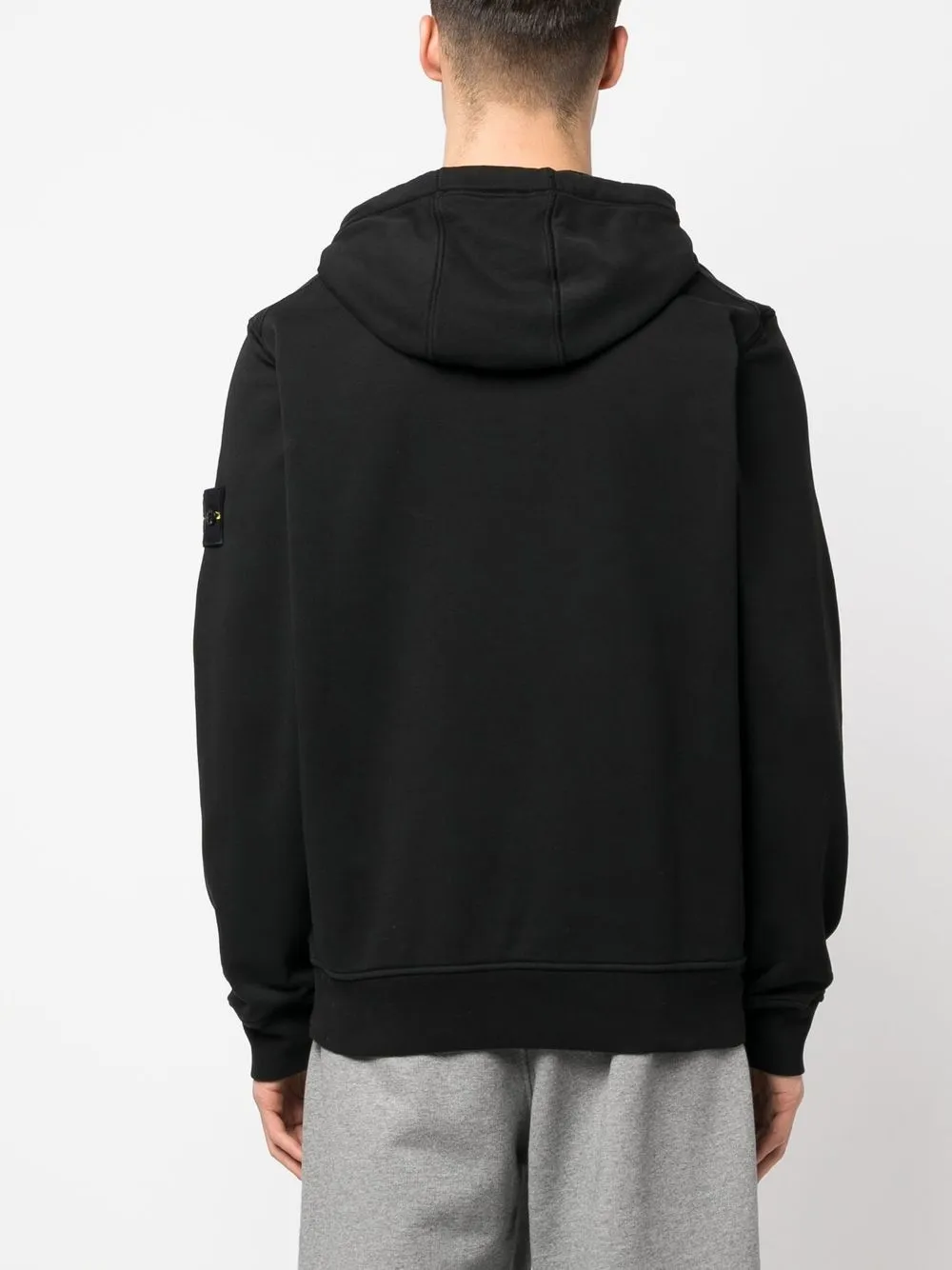 Black sweater worn by a person, showing the sweater's fit