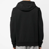 Black sweater worn by a person, showing the sweater's fit