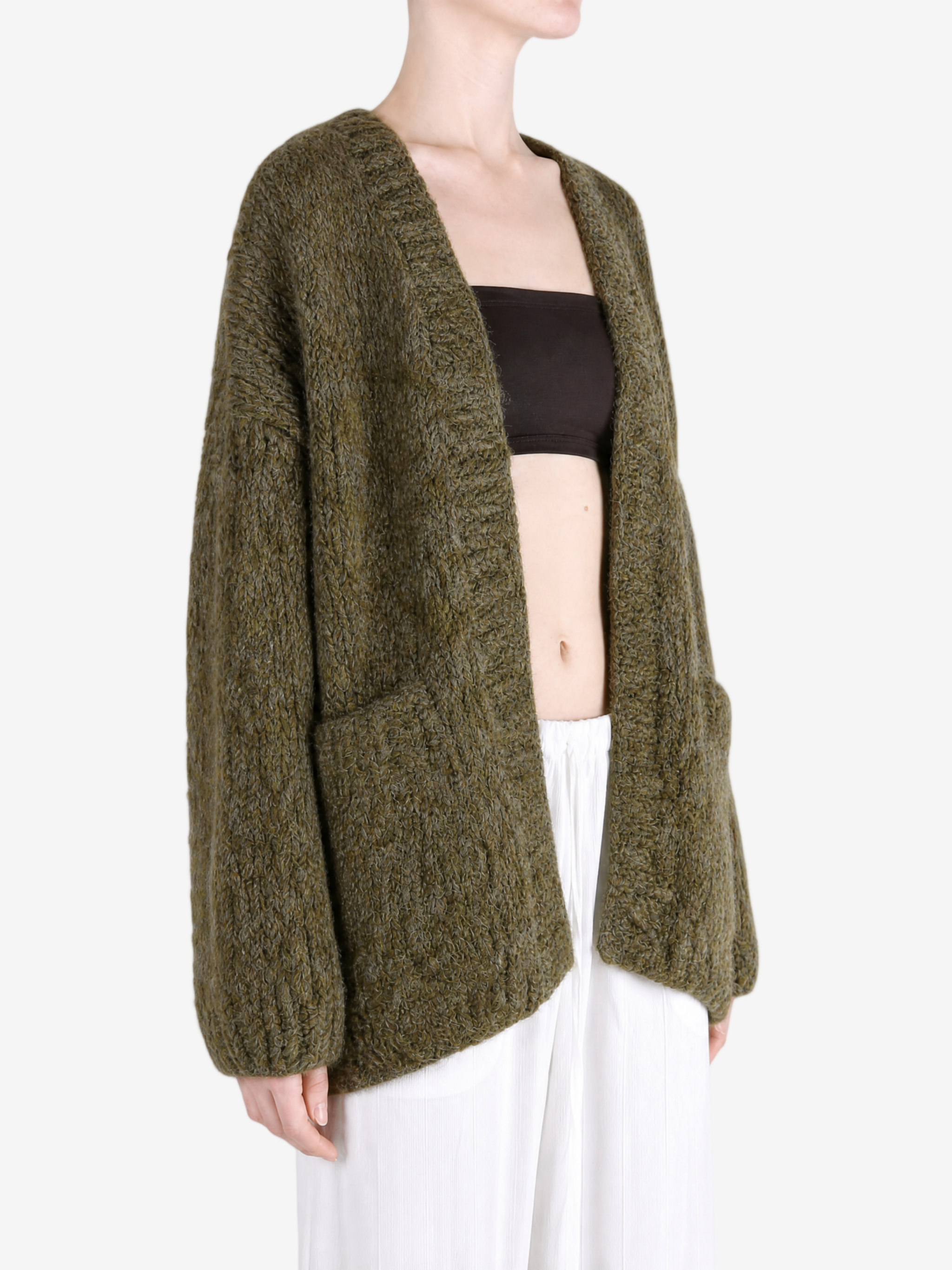 Green knitwear worn by a person, showing the knitwear fit