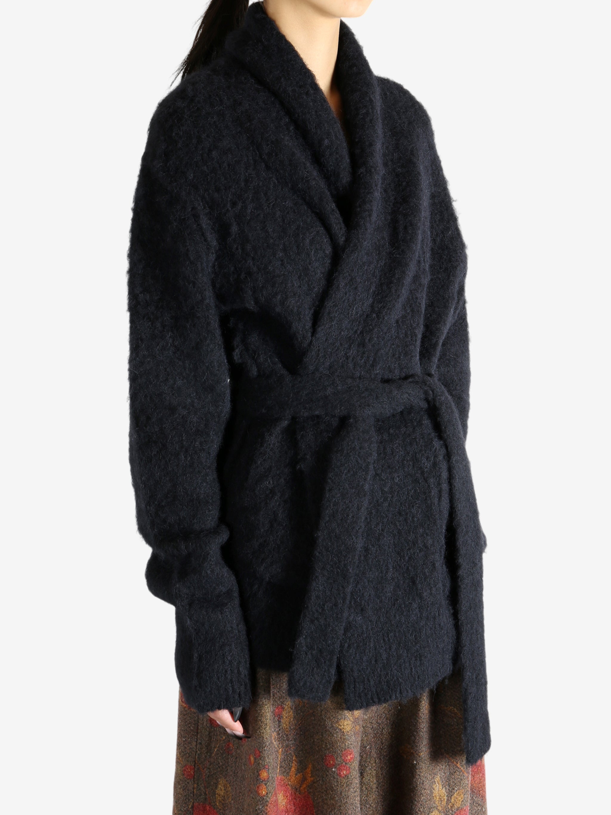 Black cardigan worn by a person, showing the cardigan fit