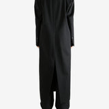 Black coats worn by a person, showing the coats fit