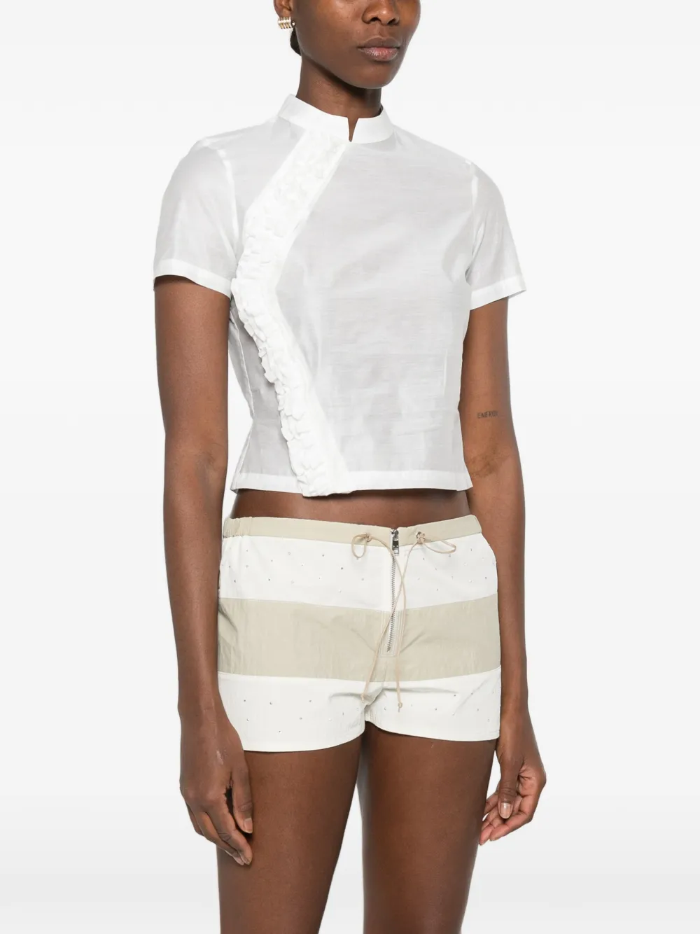 White tops worn by a person, showing the white tops' fit